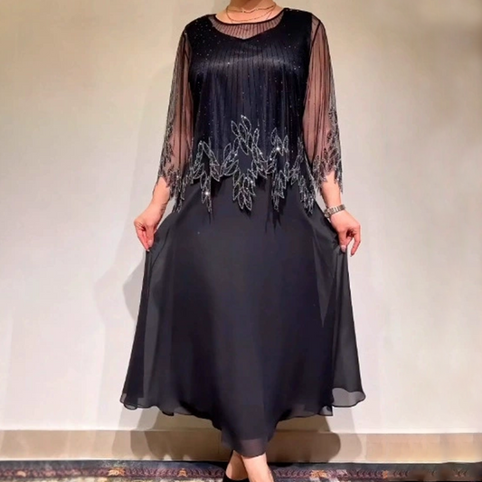 Elegancka sukienka w jednolitym kolorze z połyskującą, prześwitującą nakładką